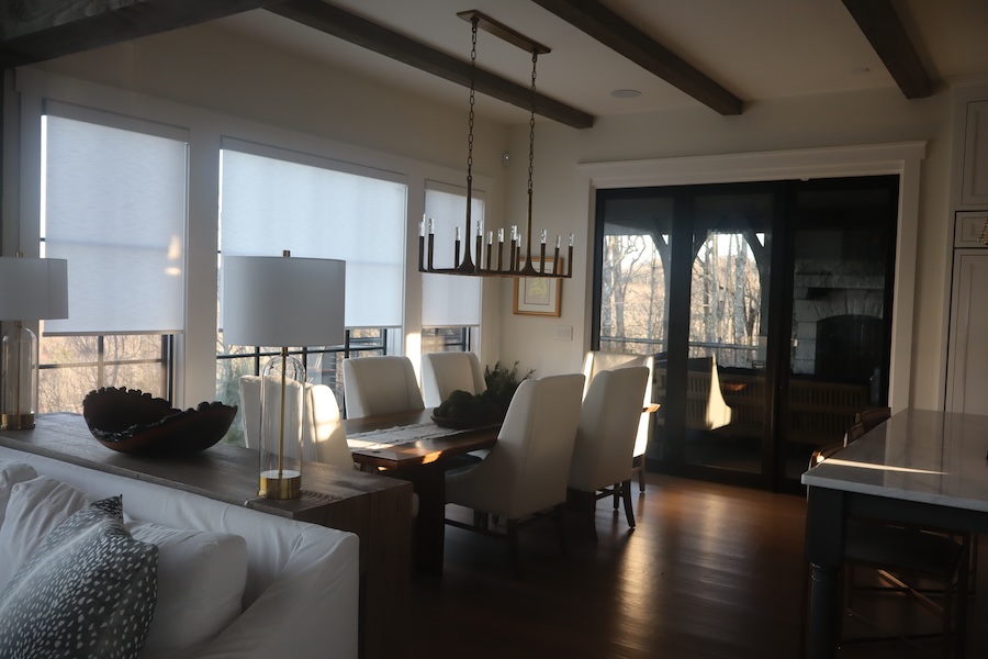 Luxury living room with partially lowered motorized shades.